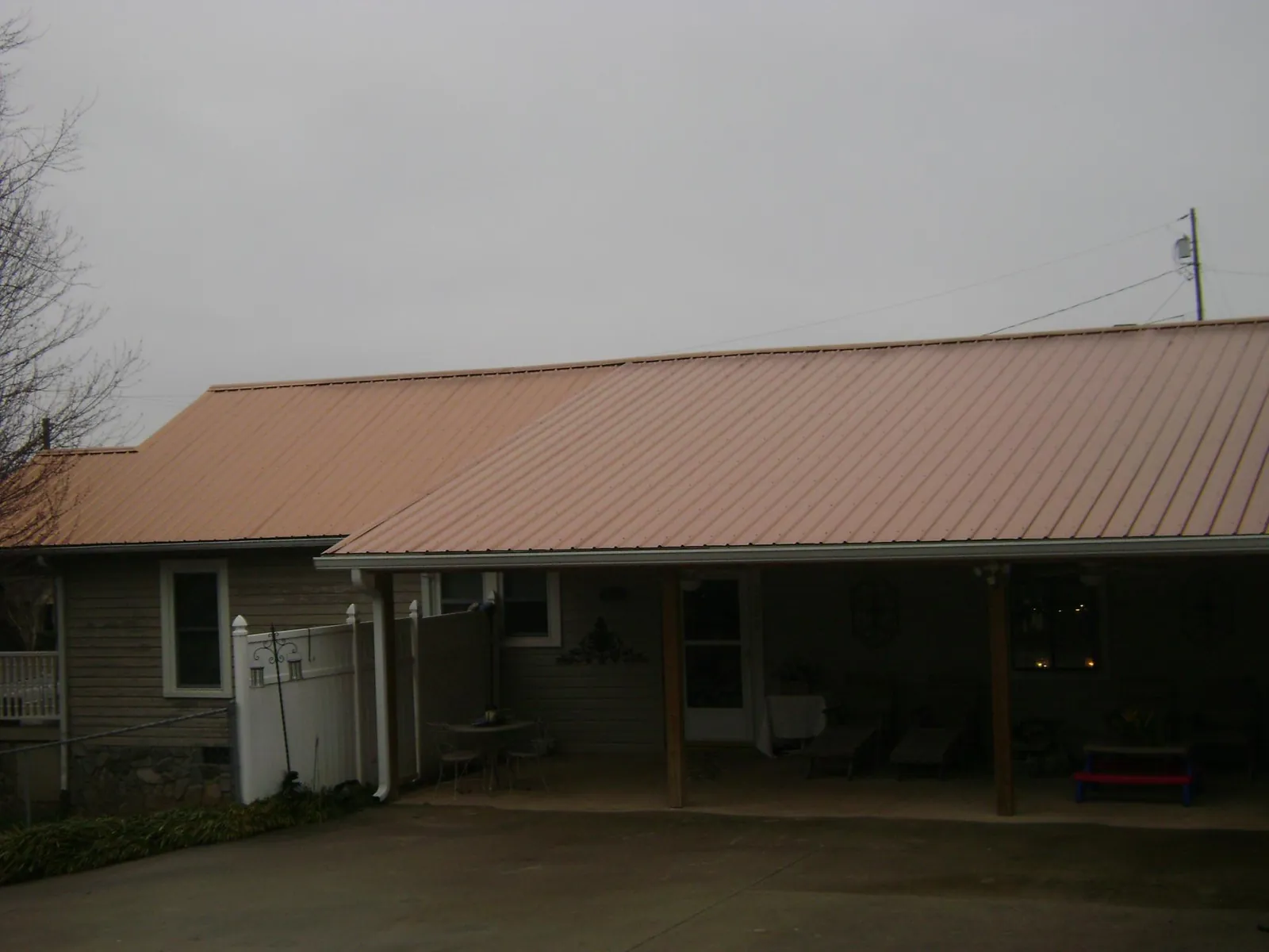 Copper toned metal roof over a wide covered patio in Ridgeland